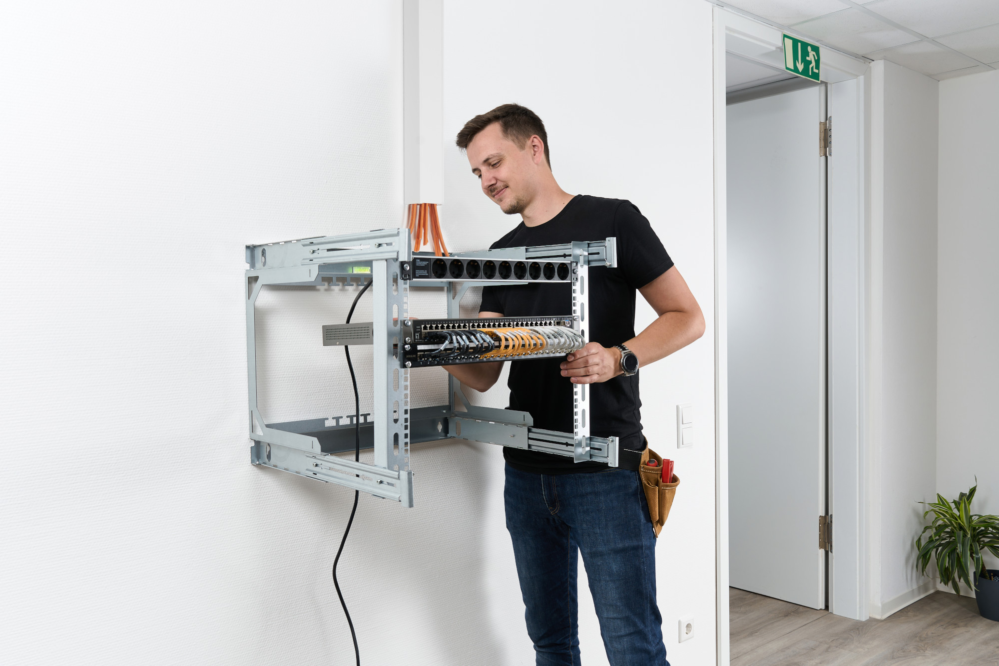 Mand fastgør komponenter til X-Rack Mand fastgør komponenter til X-Rack